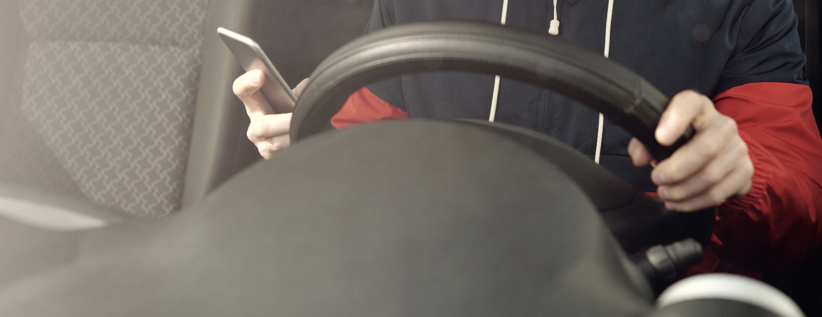 man on cell phone while driving